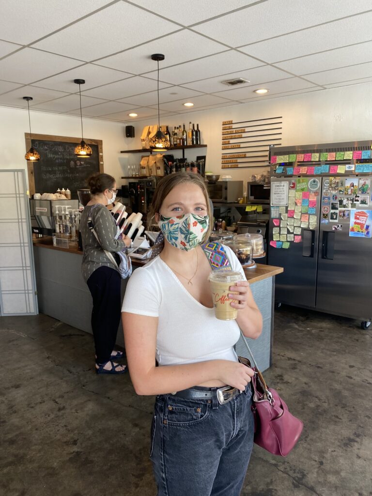 Mariah with an iced coffee at a coffee shop