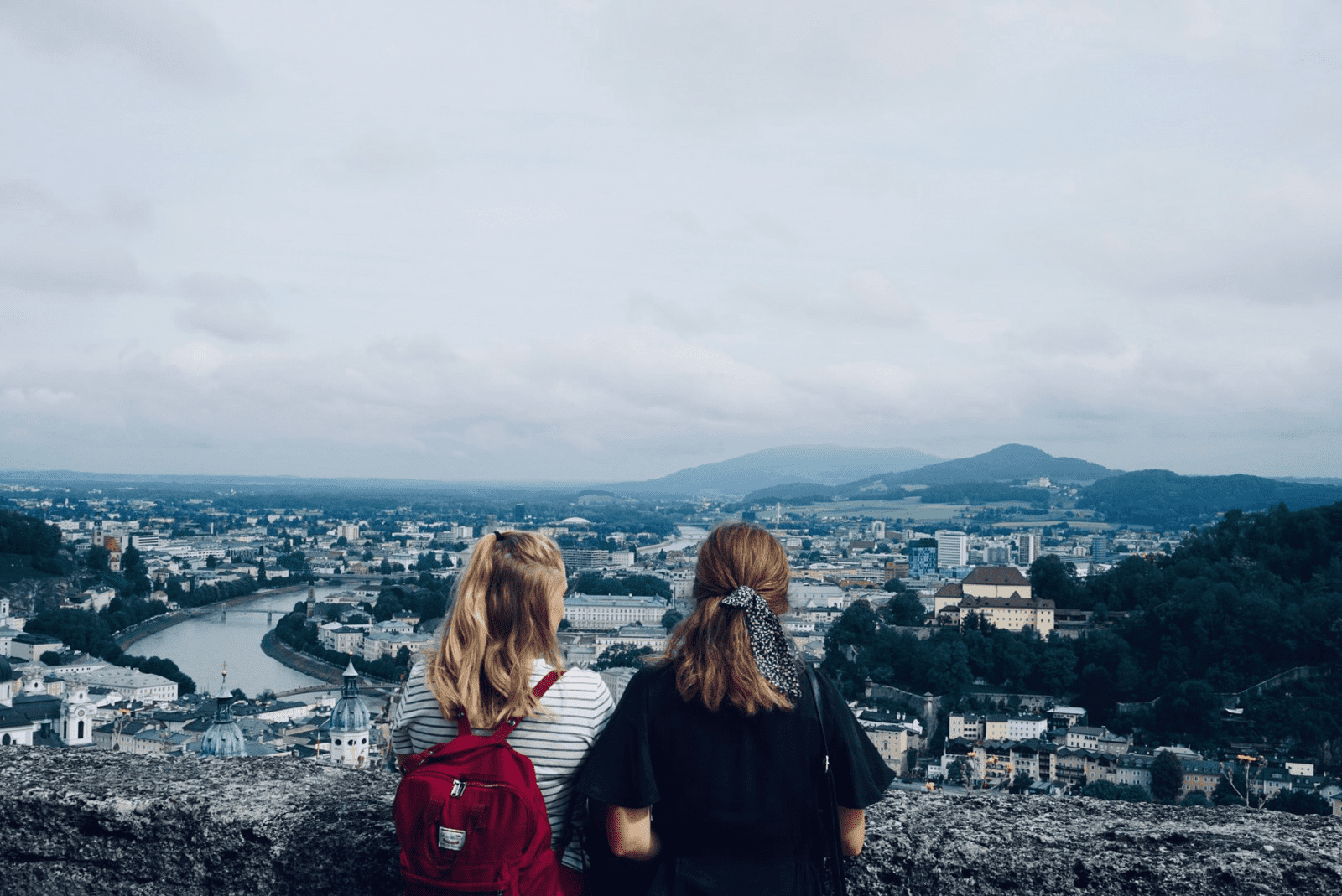 Two girls enjoying the view of a city