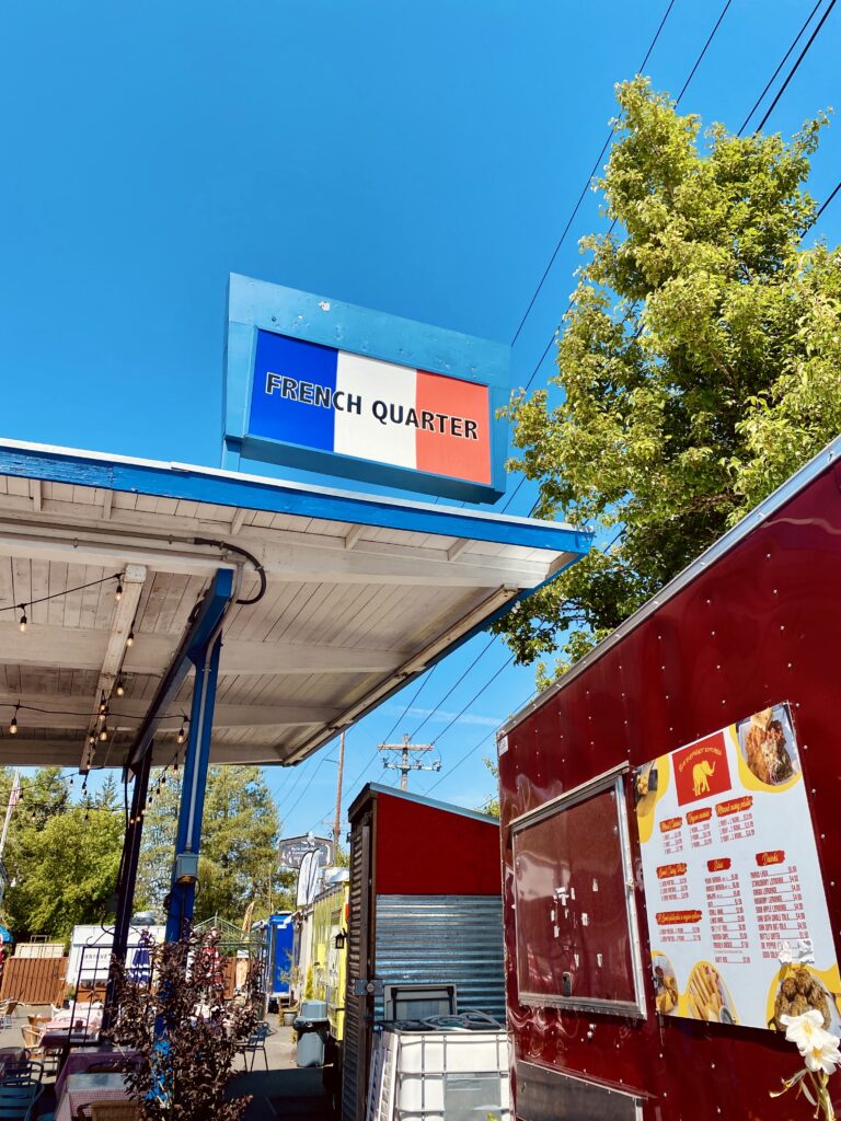 French Quarter Sign over food trucks in Multnomah Village