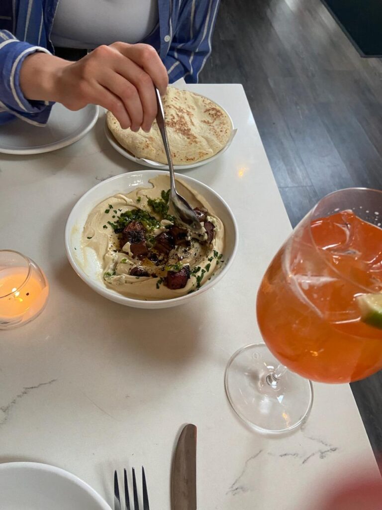 Hummus and Cocktail on table at Yalla