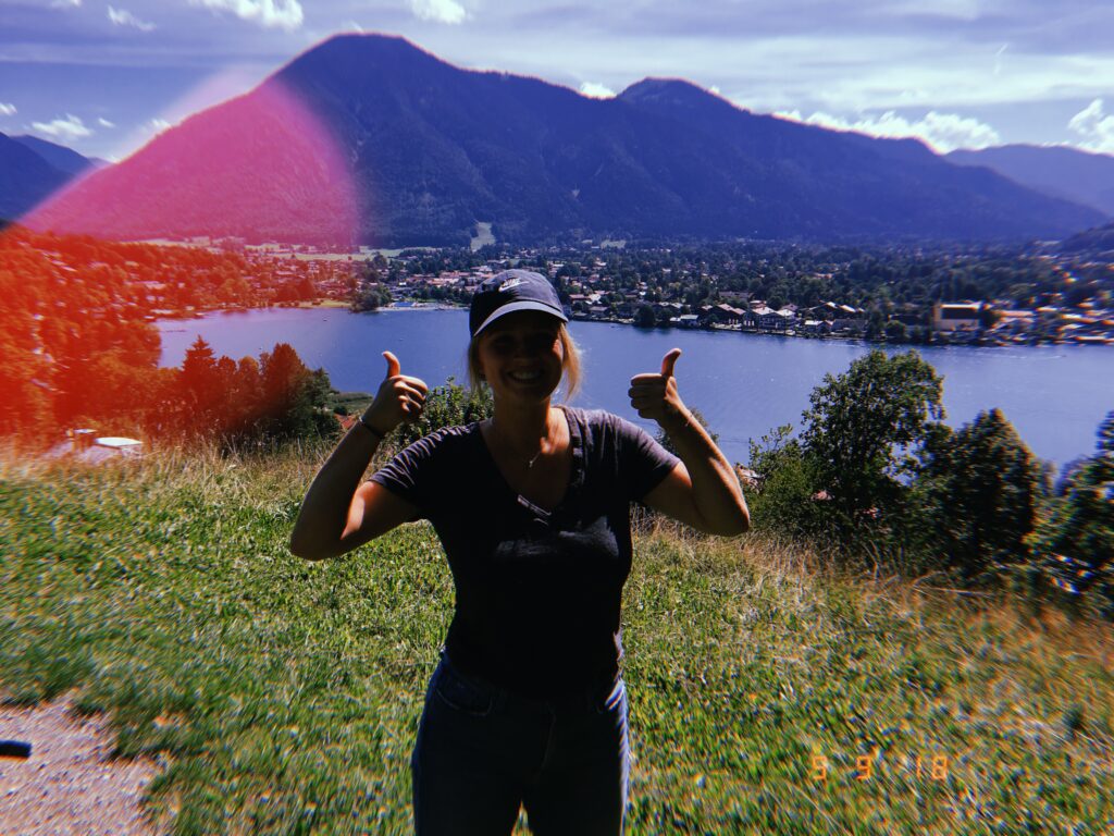 Mariah giving a thumbs up in front of a Lake and Mountain Range in Germany